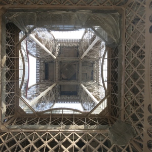 Looking up the center of the Eiffel Tower from underneath.